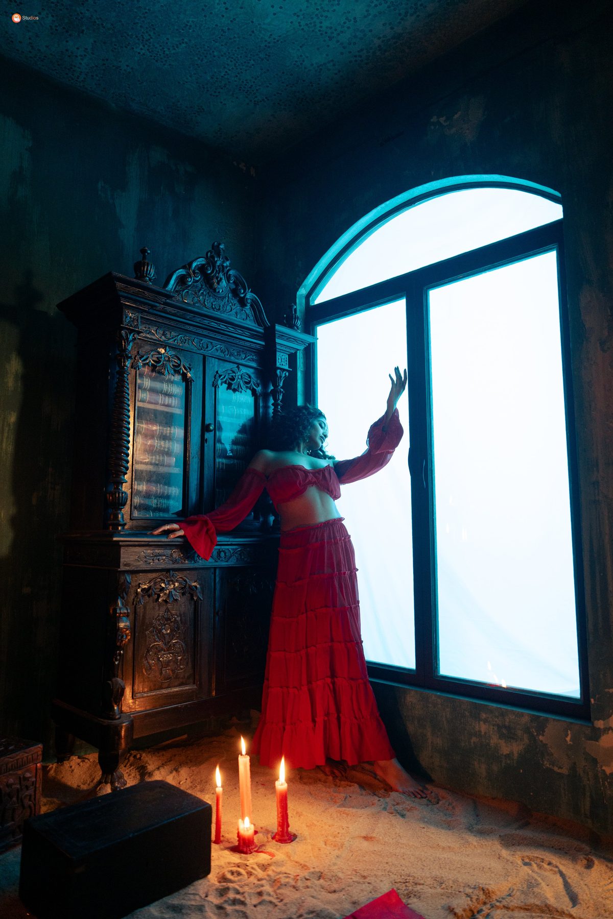 Muse in red at the arched window